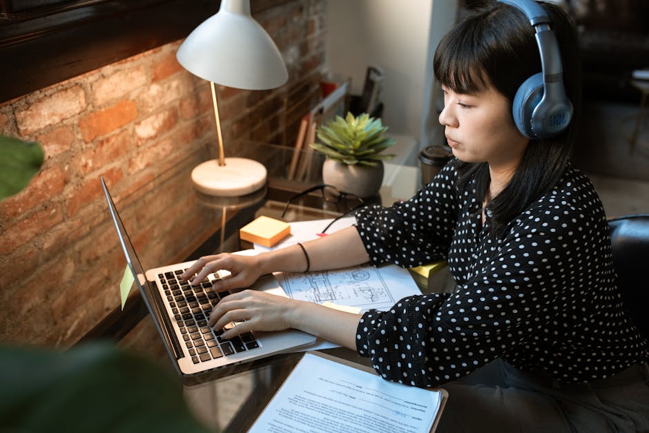 small business owner working on laptop - cost of payroll services for small business